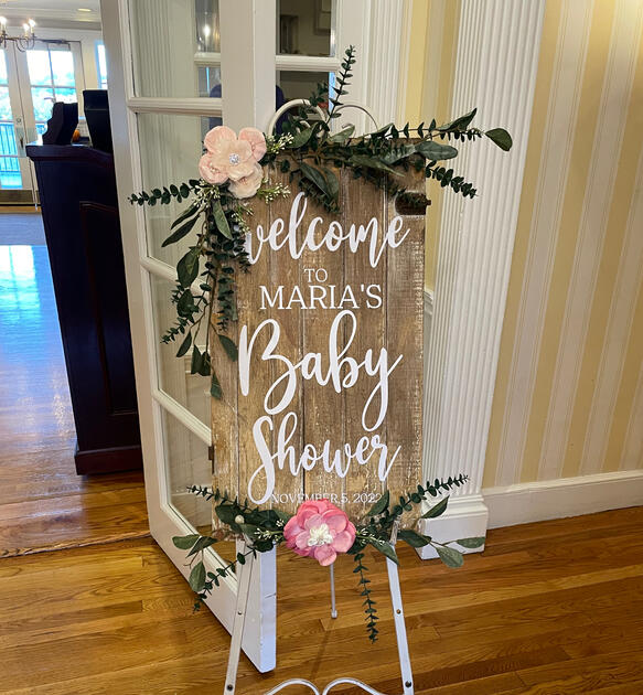 Hand-lettered rustic welcome sign styled with eucalyptus and blush florals